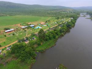 an aerial view of a village next to a river at Riverrun Resort Farmhouse in Tygerfontein