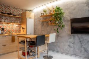 a home office with a desk and a tv at Arctic Circle Retreat: Stylish 2-Room Apartment in Rovaniemi