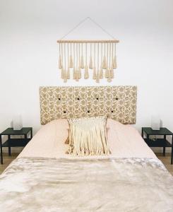 a bedroom with a large bed and a chandelier at Maison de charme au pays du vin - Charming House in Wine Country in Montcaret