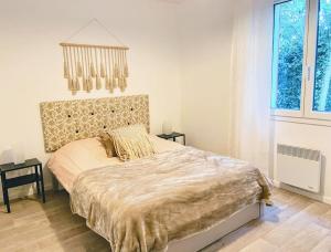 a bedroom with a large bed and a large window at Maison de charme au pays du vin - Charming House in Wine Country in Montcaret +23 photos