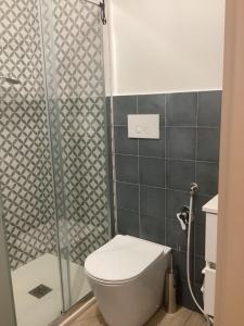 a bathroom with a toilet and a shower at Il mare a due passi in Civitanova Marche +10 photos