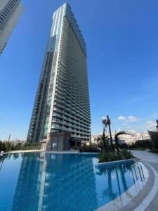 un grande edificio con una grande piscina di fronte di Sinpas Queen Bomonti istanbul a Istanbul