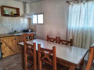 a kitchen with a wooden table and chairs in it at Nostraterra in San Rafael
