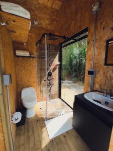 a bathroom with a shower and a toilet and a sink at Caralsol Glamping in Rionegro
