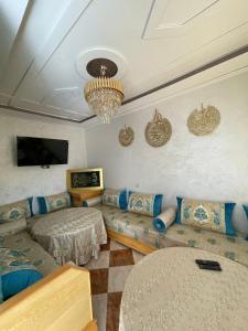 a living room with a couch and a table at Luxurious appartement in Oujda