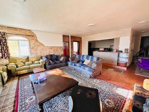 a living room with couches and a table at apartment between ajloun castle and Jerash ruins in Jerash