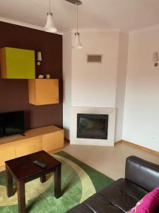 a living room with a couch and a fireplace at Apart. Dunas da Torreira in Torreira