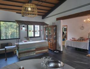 a room with a bed and a table and windows at Casa da Queira in Ares