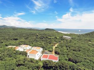 an aerial view of a house on a hill next to the ocean at Surf Ranch Resort - Popoyo in Popoyo +154 photos