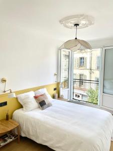Un dormitorio con una cama blanca grande y una ventana en Cosy Saussier - Confort - Ideal Place, en Troyes