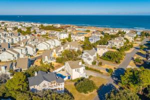 an aerial view of a residential neighborhood with houses and the ocean at Villa Del Mar in Corolla