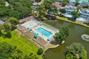 an aerial view of a house with a pool in the water at Villa Del Mar in Corolla