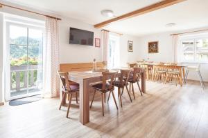 a dining room with a table and chairs at Gästehaus Kulmer in Hopfgarten im Brixental