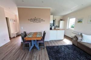 a living room with a table and a couch at Haus am Merr auf Fehmarn OT Westerbergen in Albertsdorf