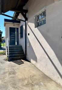 a house with a blue door and stairs on it at Ferienwohnung Pfaffensteinblick in Hirschbach