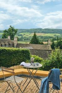 a table and two chairs sitting on a patio at A Digital Detox in the Cotswolds - Langley Barn in Winchcombe