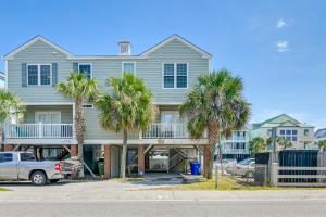 a house with palm trees in front of it at Surfside Beach House with Pool, Walk to Beach and Pier in Myrtle Beach