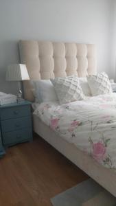 una camera con letto, lampada e comodino di Knockrobin Cottage a Wicklow