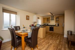 a kitchen and dining room with a table and chairs at Swallow View, A Spacious Base with stunning views in Matlock
