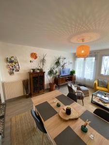 uma sala de estar com uma mesa e um sofá em Chambre chez l'habitant proche centre em Brest