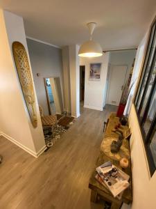 a living room with a surfboard on the wall at Chambre chez l'habitant proche centre in Brest