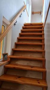 a staircase with wooden treads in a house at Oāze Ģimenei in Pāvilosta