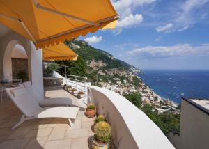 a balcony with chairs and a view of the ocean at fior di lino in Positano