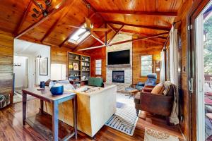 a living room with wooden walls and a ceiling at Cozy Riverview Cabin in Forestville