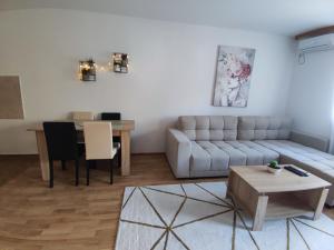 a living room with a couch and a table at Alacaster in Novi Sad