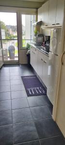 a kitchen with a white refrigerator and a tile floor at COSY APPARTMENT 3 BEDSROOM in Antwerp