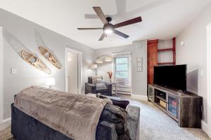 a bedroom with a bed and a flat screen tv at Vermont Marble Haven - Unit 1 in Rutland