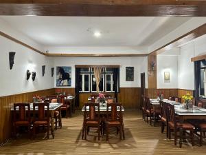 a dining room with tables and chairs in a restaurant at Hotel Norling SK Groups in Pelling