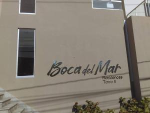 a white building with a sign on the side of it at Boca del mar, apartamento 207/206 in Cuevas