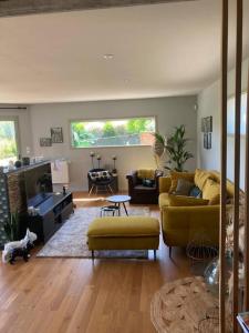 a living room with a couch and a table at Maison individuelle - Cucq in Merlimont