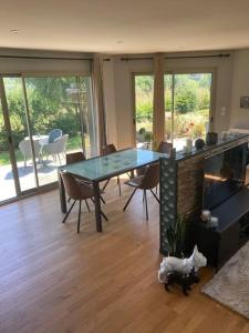 a living room with a table and chairs and a dining room at Maison individuelle - Cucq in Merlimont