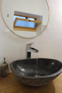 a sink in a bathroom with a mirror at calMar Tenerife 1 in Los Realejos