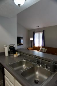 a kitchen with a stainless steel sink and a couch at Cloud's Bnb - The Signature Suite, for cooks. in Elizabethtown