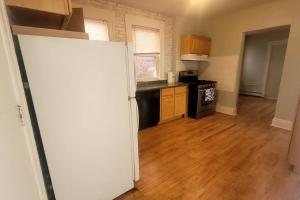 an open door to a kitchen with wooden floors at Amazing Location Train/NYC,Cafes in Montclair