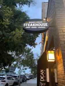 a sign for a steakhouse on the side of a building at Studio by New York Harbor in Saint George