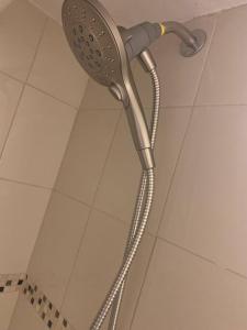 a shower head on the wall of a shower stall at Studio by New York Harbor in Saint George