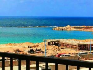 a building under construction next to a body of water at City Square - Apartments With Stunning Sea View in Alexandria