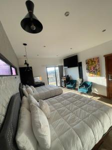 a large bed in a bedroom with a large white bedvisor at TEMEXKAL RESORT in Ensenada