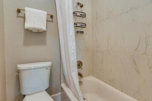 a bathroom with a white toilet and a shower at Spokane Vacation Rental with Central Location! in Spokane +19 photos