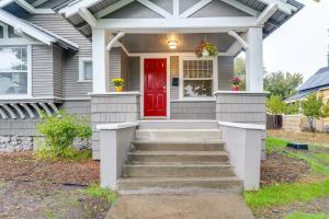 a house with a red door and stairs at Spokane Vacation Rental with Central Location! in Spokane