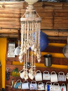 a chandelier made out of shells hanging from a wall at Huanchaco Surf Camp in Huanchaco