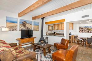 a living room with a couch and a fireplace at Fort Marcy Suites by All Seasons Resort Lodging in Santa Fe
