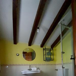 a bathroom with a mirror and a sink at Casa Capricho in Proaza +18 photos
