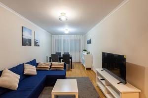 マトジニョシュにあるPorto FishLand Apartmentのリビングルーム(青いソファ、テレビ付)