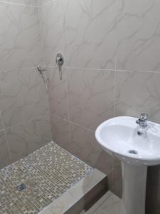 a bathroom with a sink and a shower at Airport Airbnb in Richards Bay
