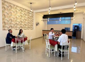 a group of people sitting at tables in a restaurant at Hotel Presidencial in Chiclayo